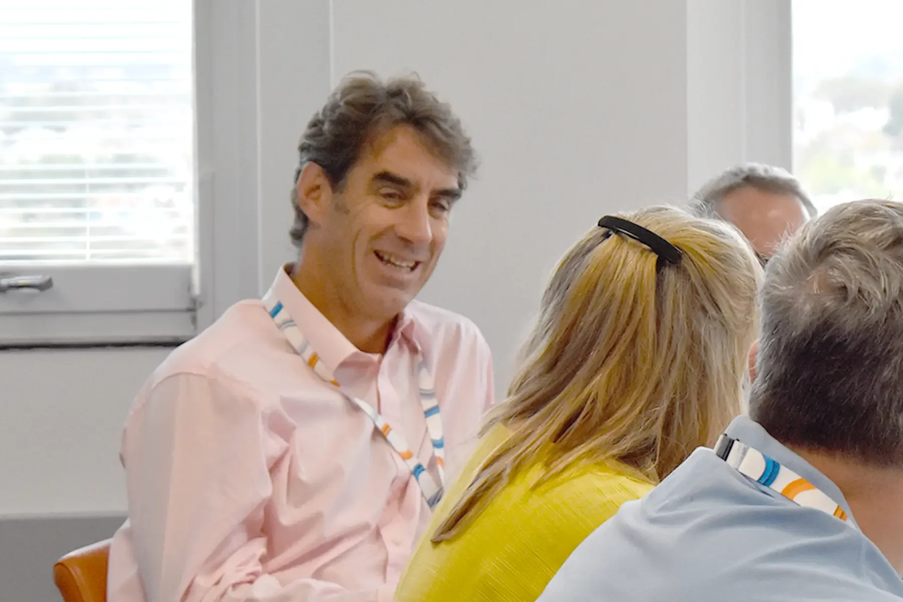 Man laughing in a team meeting