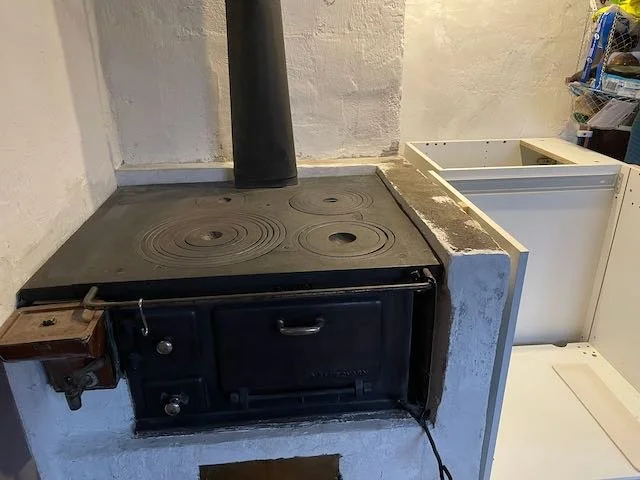 Side leveled next to old wood fired stove