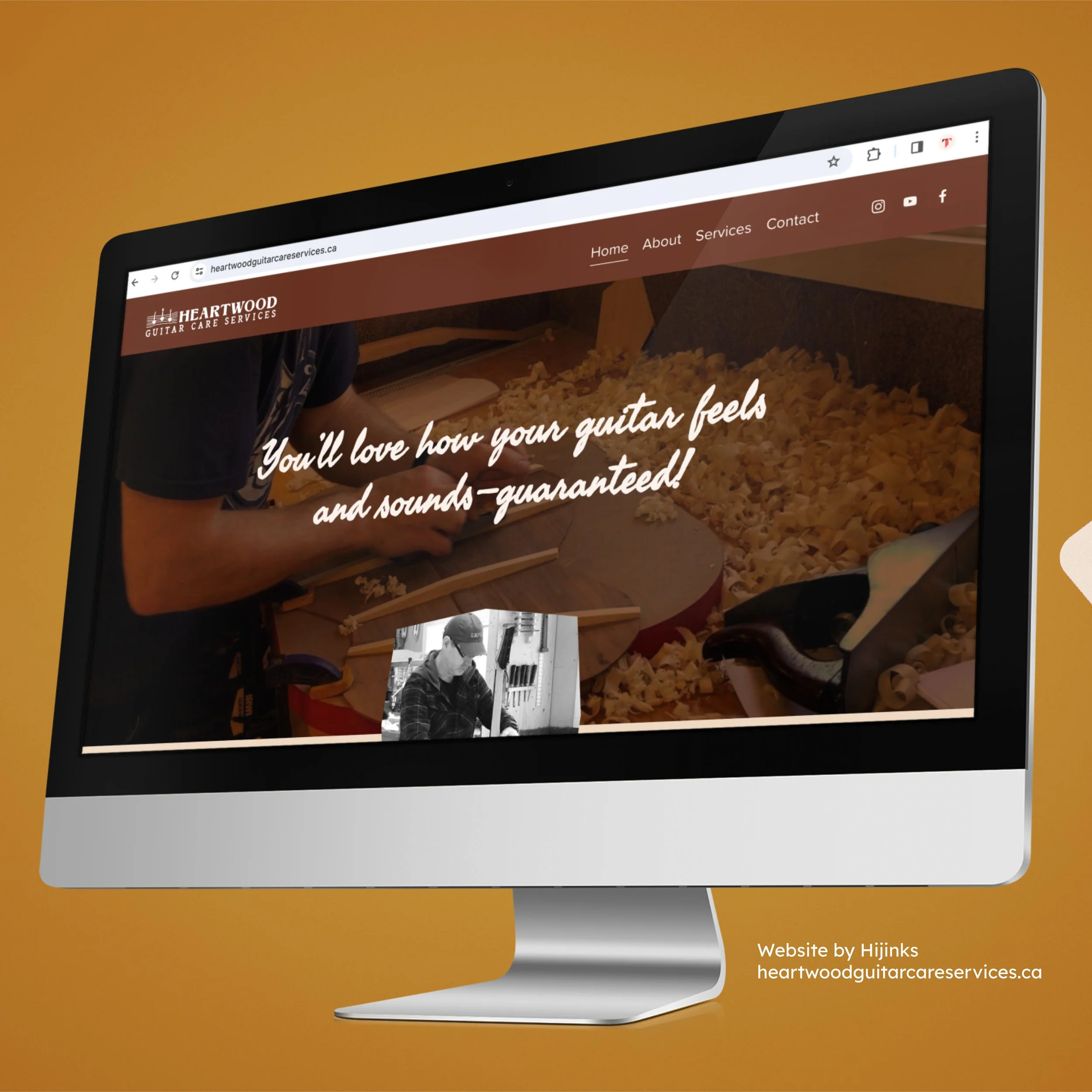 Computer monitor displaying a website for Heartwood Guitar Care Services with a background image of a person shaping a guitar body with wood shavings on the table, and a small black and white photo of a person working on a guitar. - Hijinks Design
