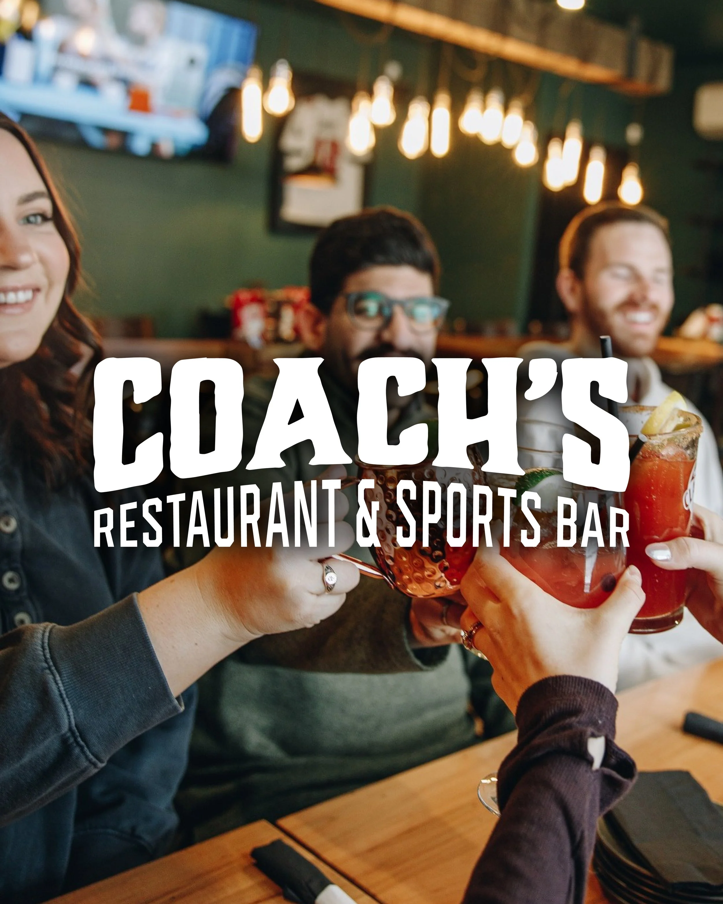 A group of friends at a restaurant and sports bar raising glasses of drinks in a toast. - Hijinks Design Agency