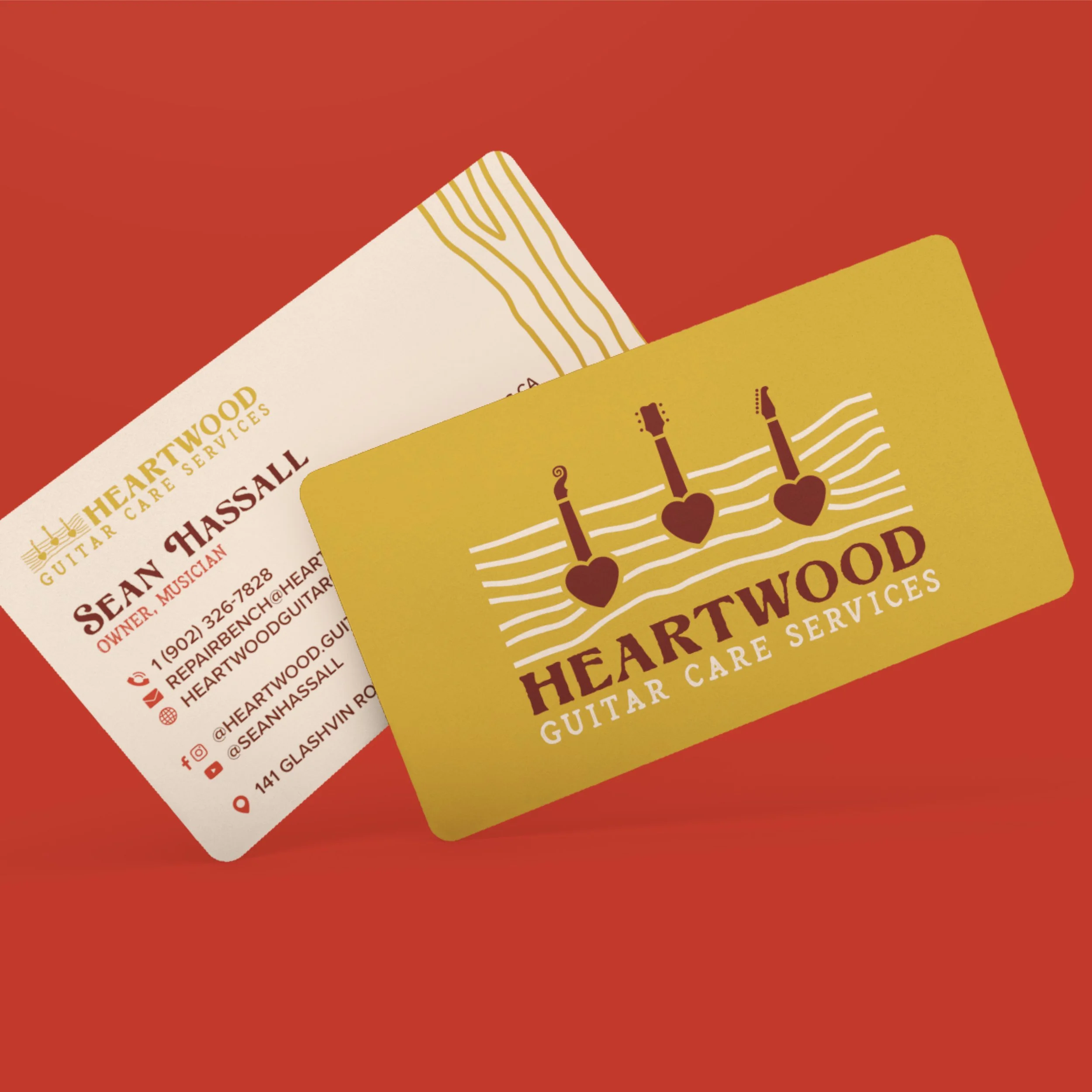 Business cards for Heartwood Guitar Care Services, featuring logo with two guitars and hearts, and contact information for Sean Hassall.