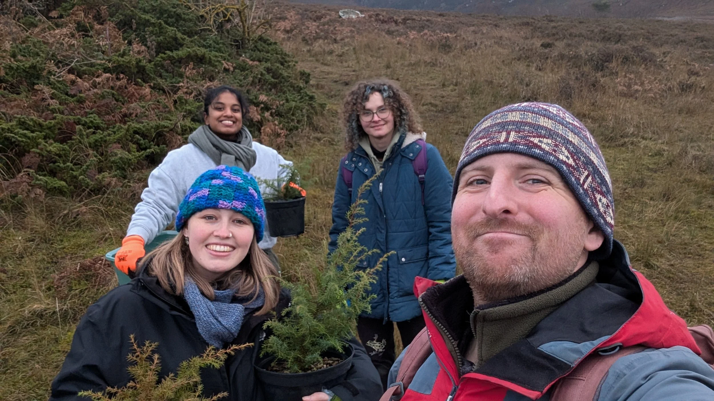 Four happy staff members