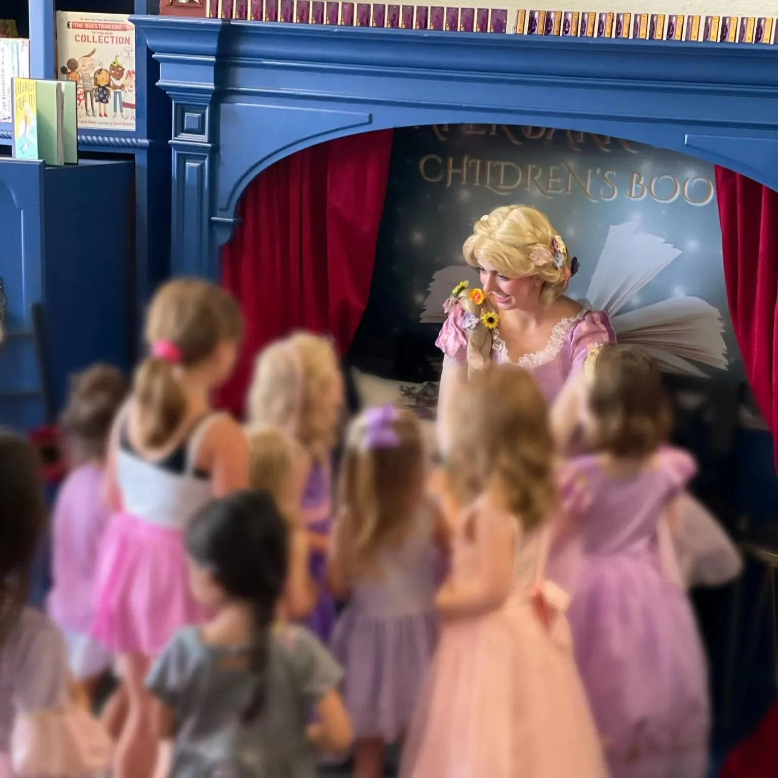 Children around Princess Rapunzel during storytime.