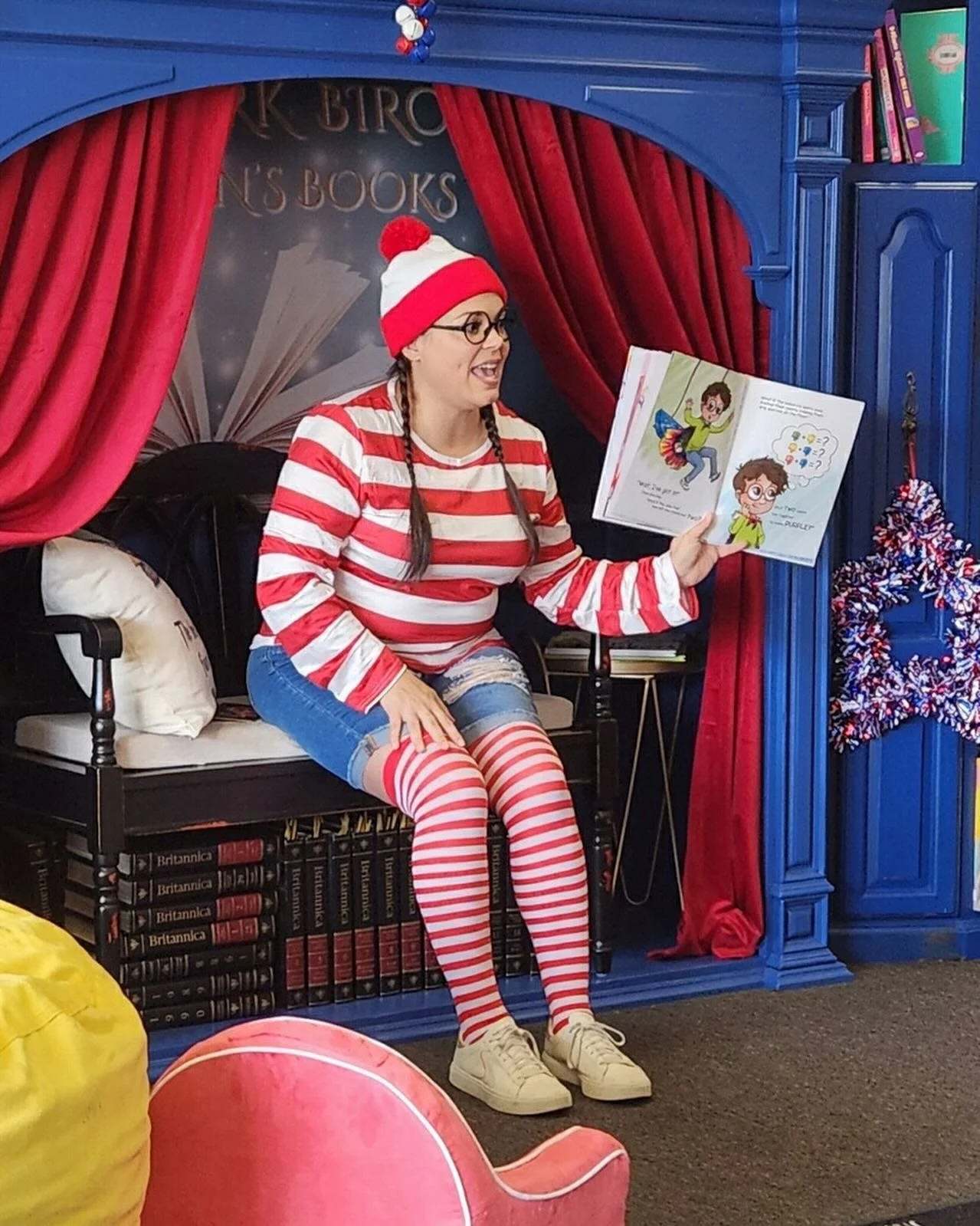 Store owner reading to kids during Find Waldo Local