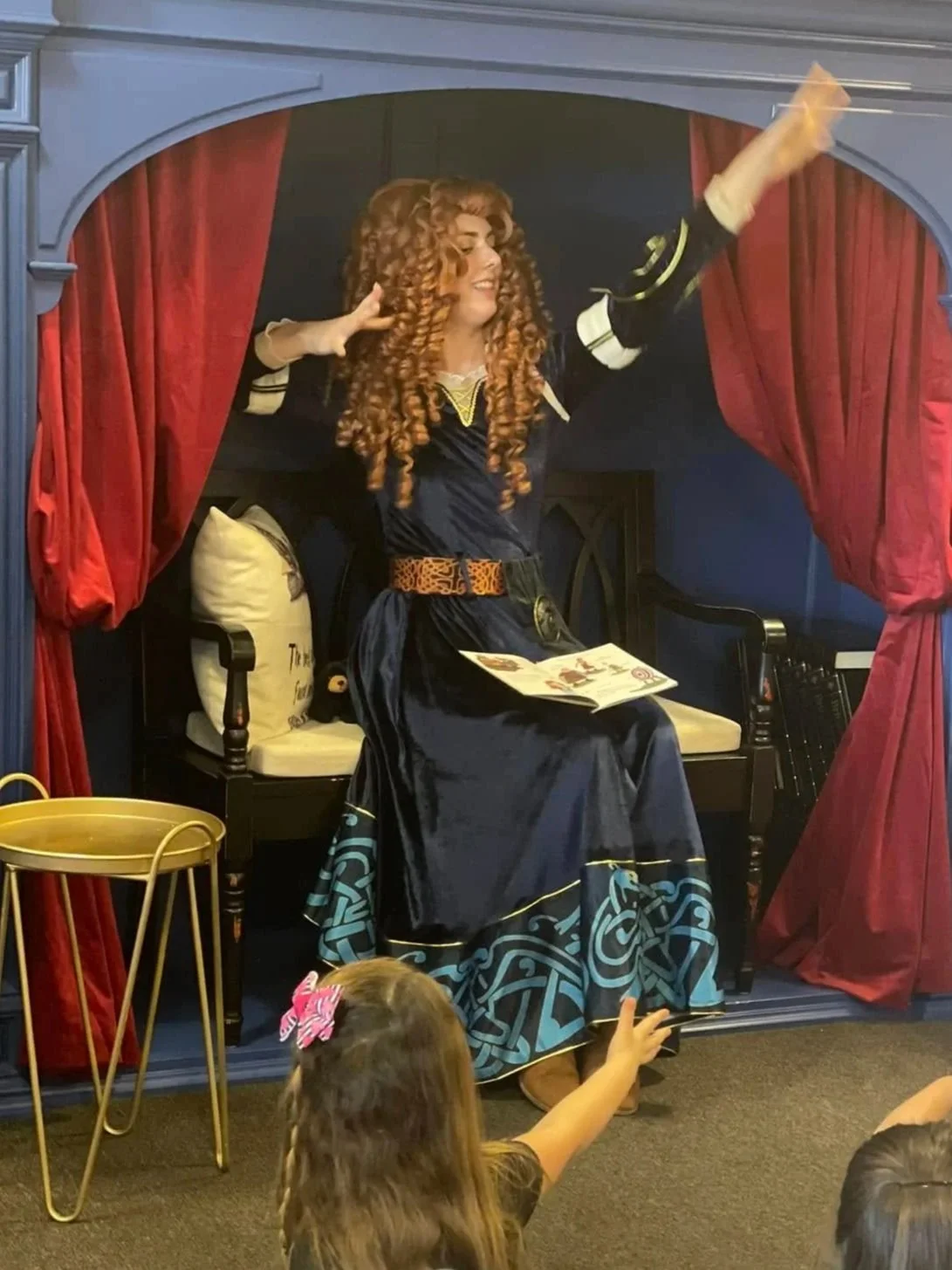 Princess Merida reading to kids during monthly princess storytime