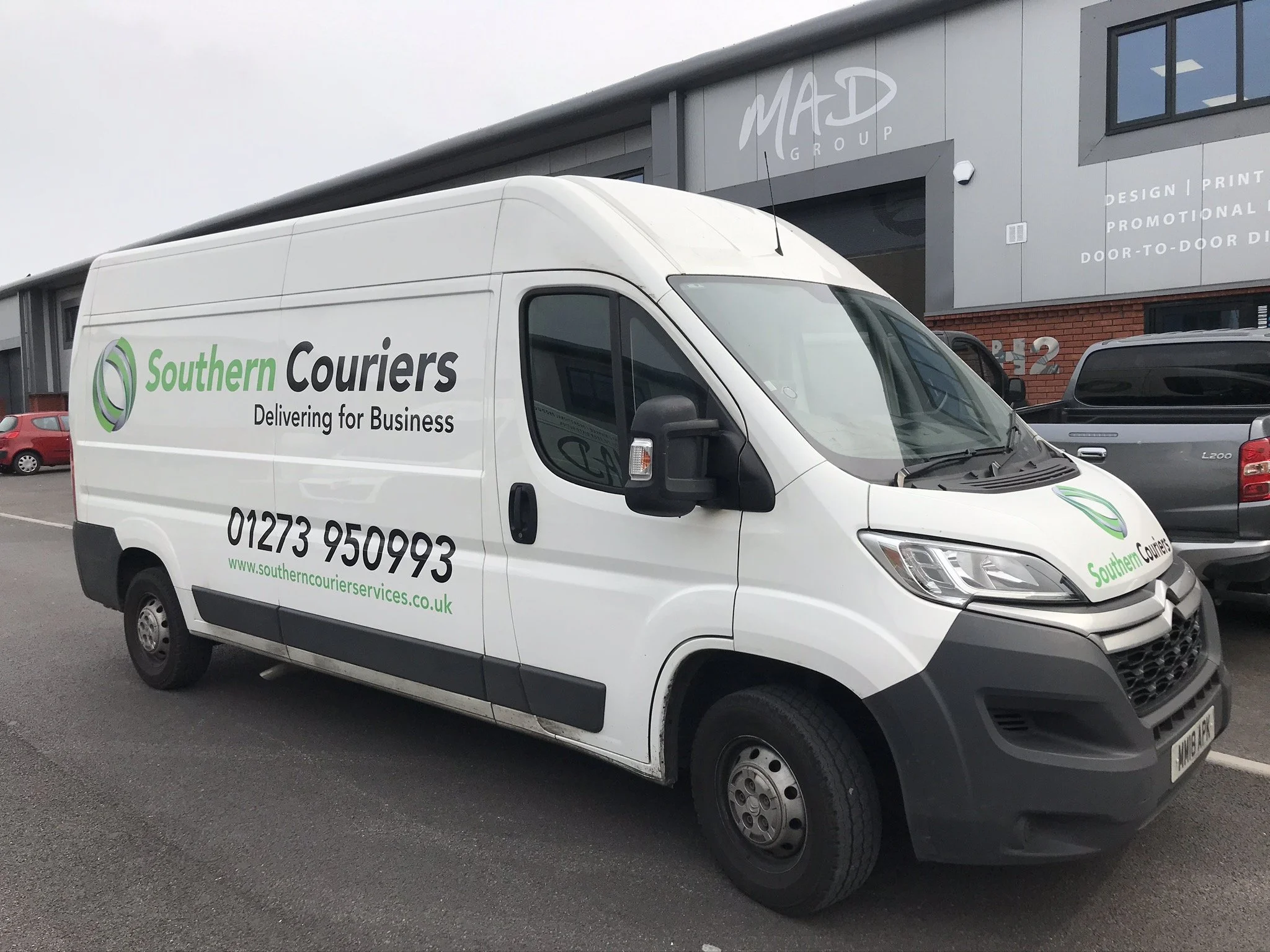 Scenic shot of the beach with waves hitting the rocks.