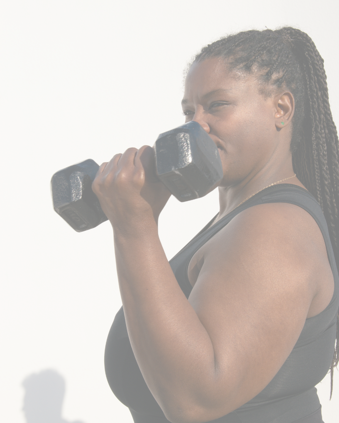 Woman lifting a black dumbbell with a white background