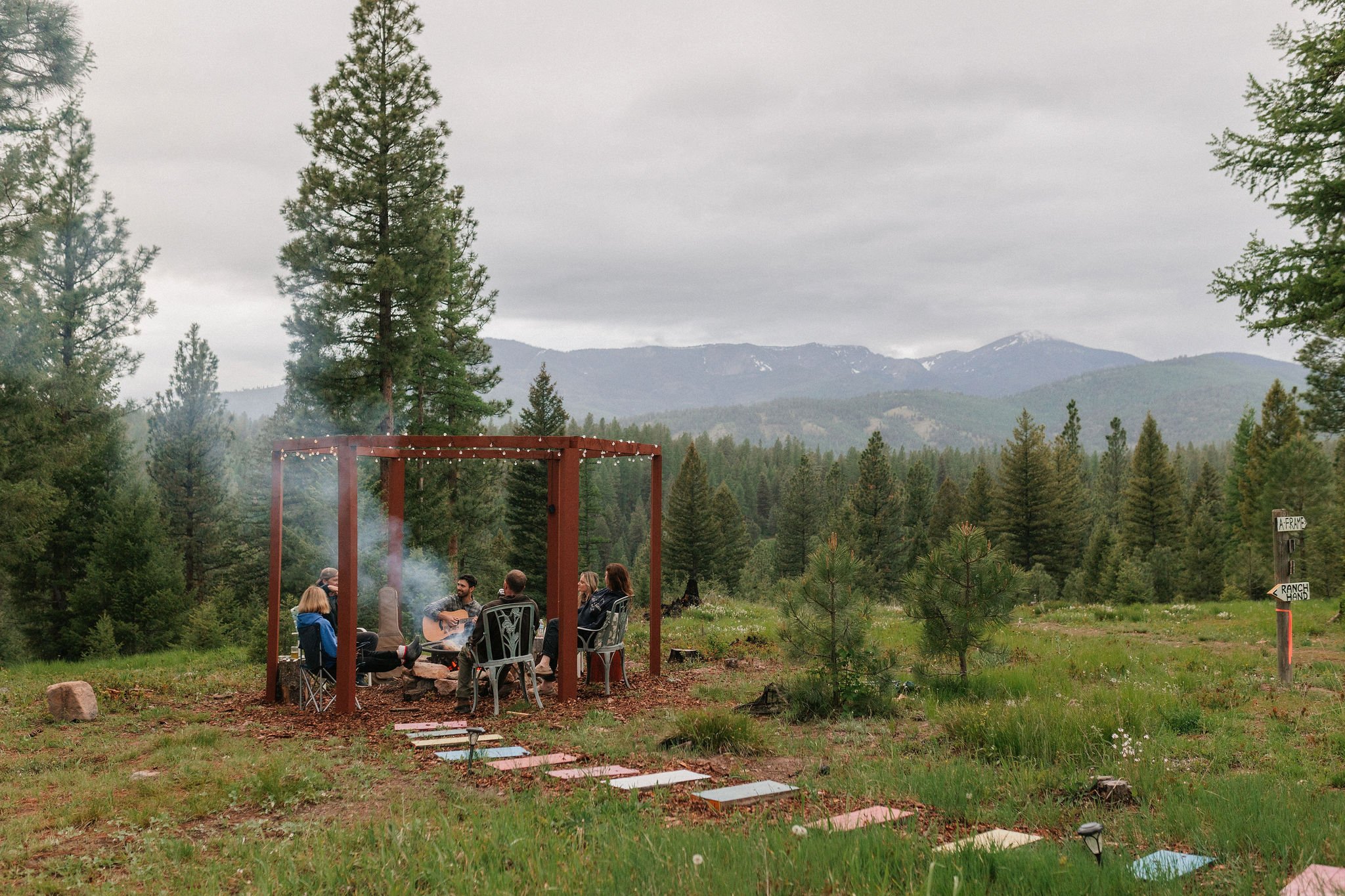 Connect with other guests at the communal fire pit and enjoy the majestic mountain views at The Hohnstead Glamping Cabins Resort.