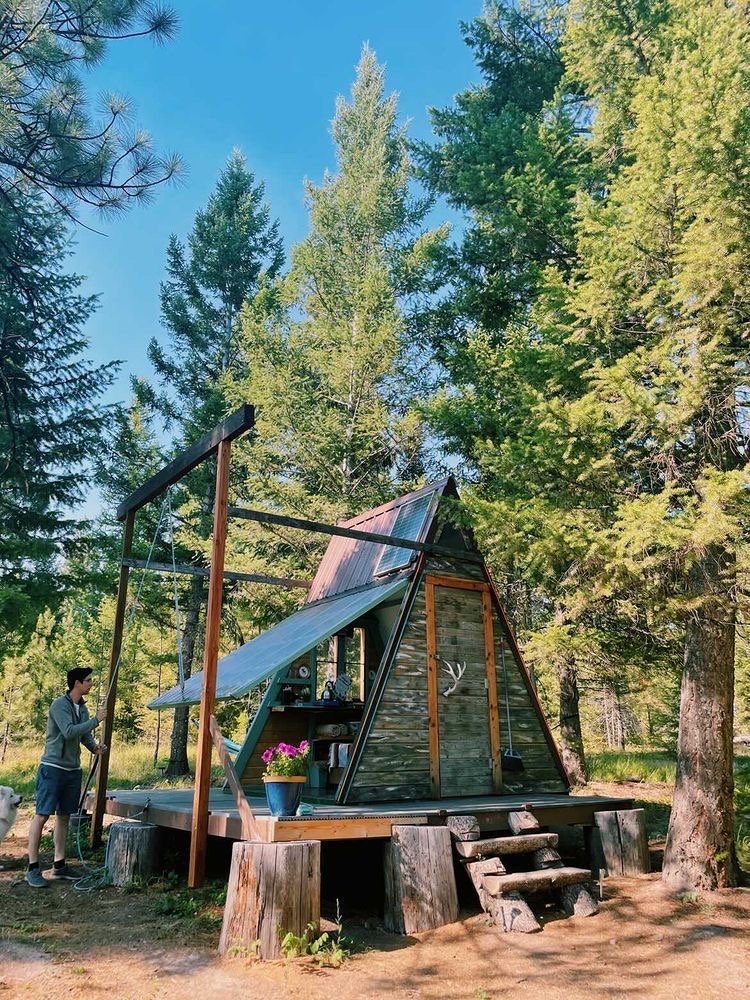 Lifting the transforming wall at The A-frame Cabin at The Hohnstead Glamping Cabins Resort near Missoula, Montana
