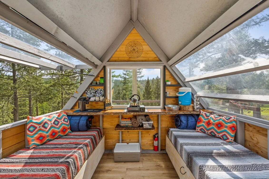 View from the bedside of The Blind micro-cabin, showing how guests can watch the stars and forest without lifting their heads from the pillow.