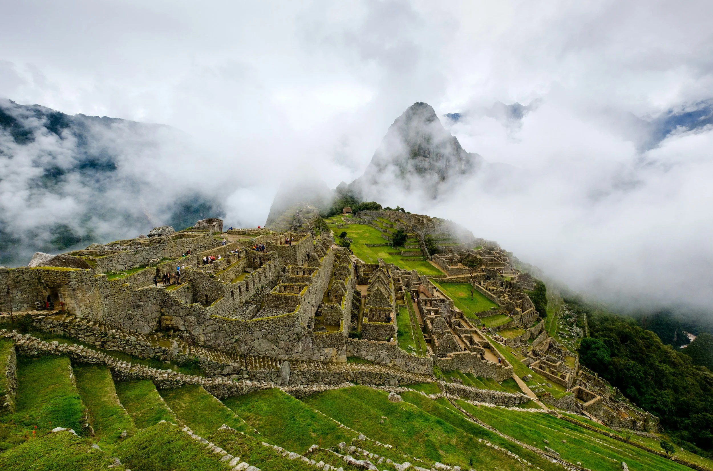 Panoramic view of Machu Picchu ruins in Peru surrounded by misty Andes mountains