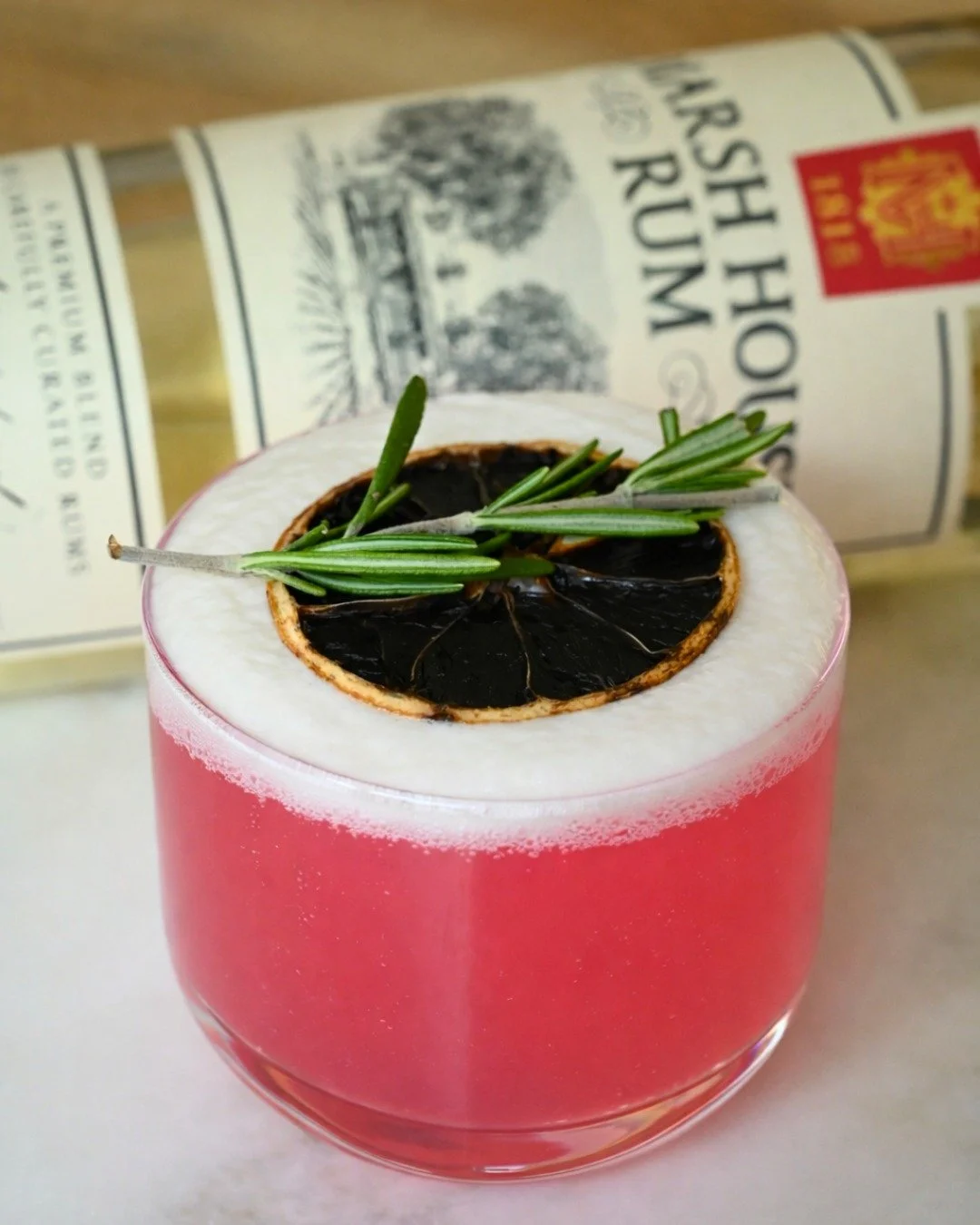 Porch season's back, and we've got the drink for it. The Garden District Fizz...looks fancy, drinks easy, and that rosemary-charred citrus combo hits different when the weather's just right.

🍹 Garden District Fizz Recipe:
&bull; 2 oz Marsh House Ru
