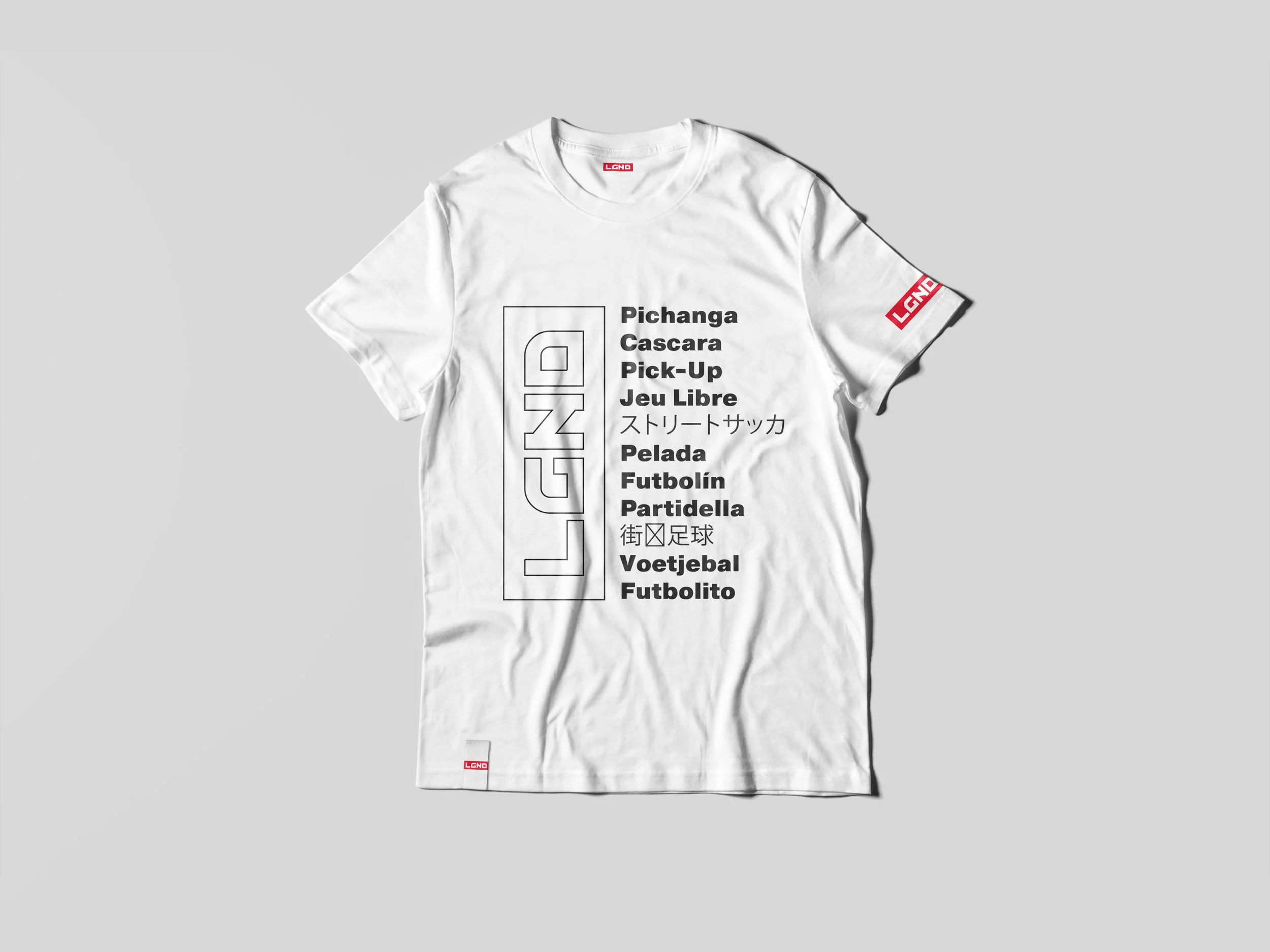 A white T-shirt with black and red text and graphics. The front features a vertical rectangular outline with the word 'LGN' inside, and a list of words related to soccer, including some in different languages.
