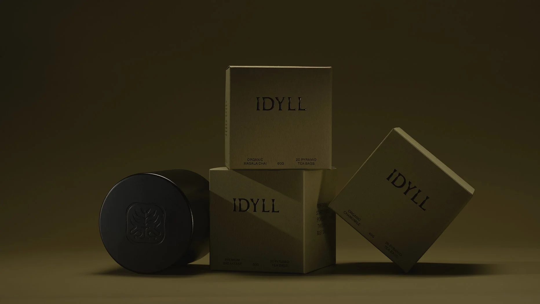 A collection of beige boxes with the brand name IDYLL printed on them, along with a black container with a floral emblem. The boxes are stacked and tilted, containing organic tea bags and breakfast items, set against a dark background.