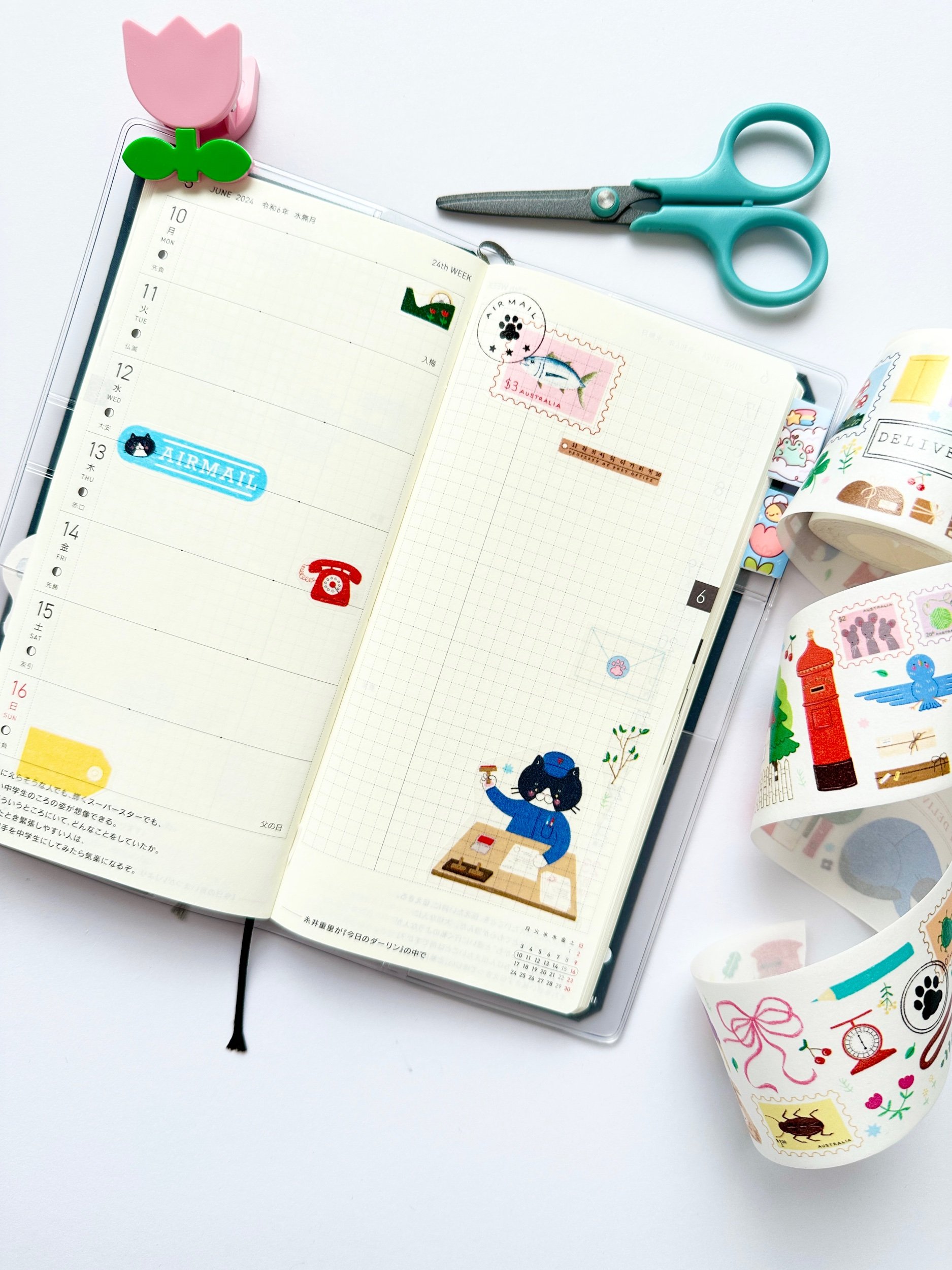 paper washi tape of a postman cat delivering mail. Journal spread showing how the tape can used if the designs are cut up