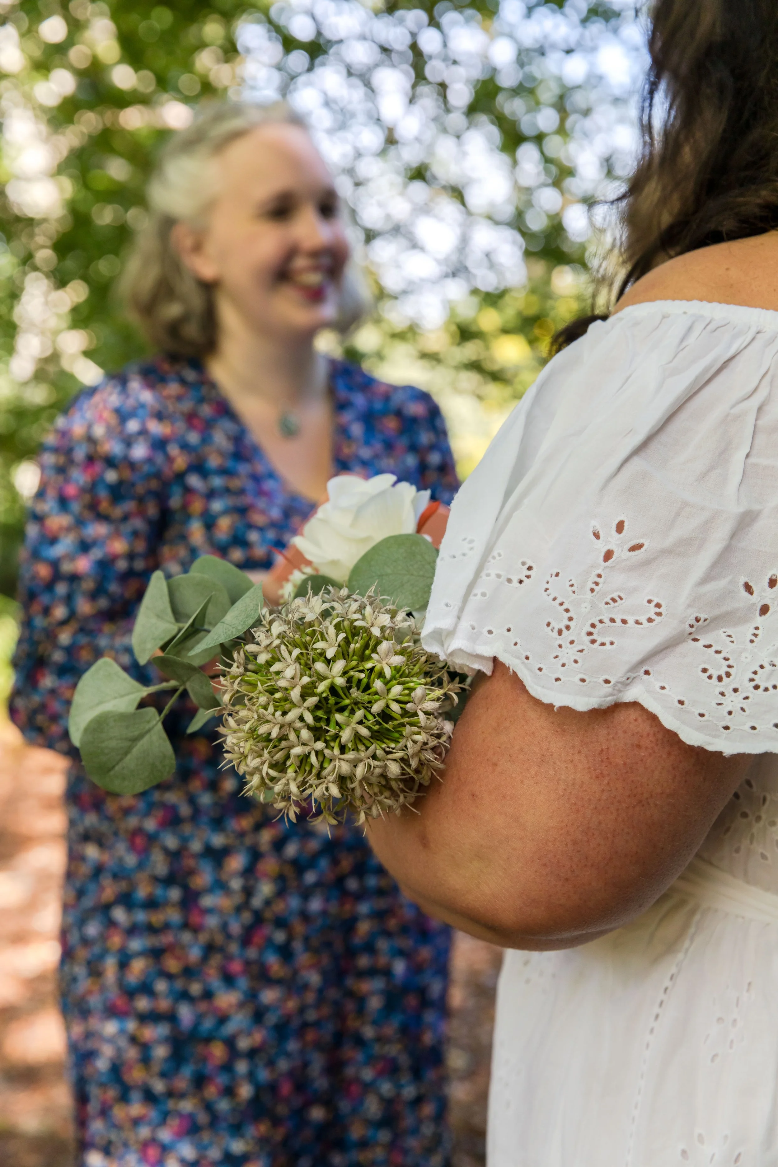 Celebrant Claire Dunford delivers wedding ceremony as bride cradles flowers