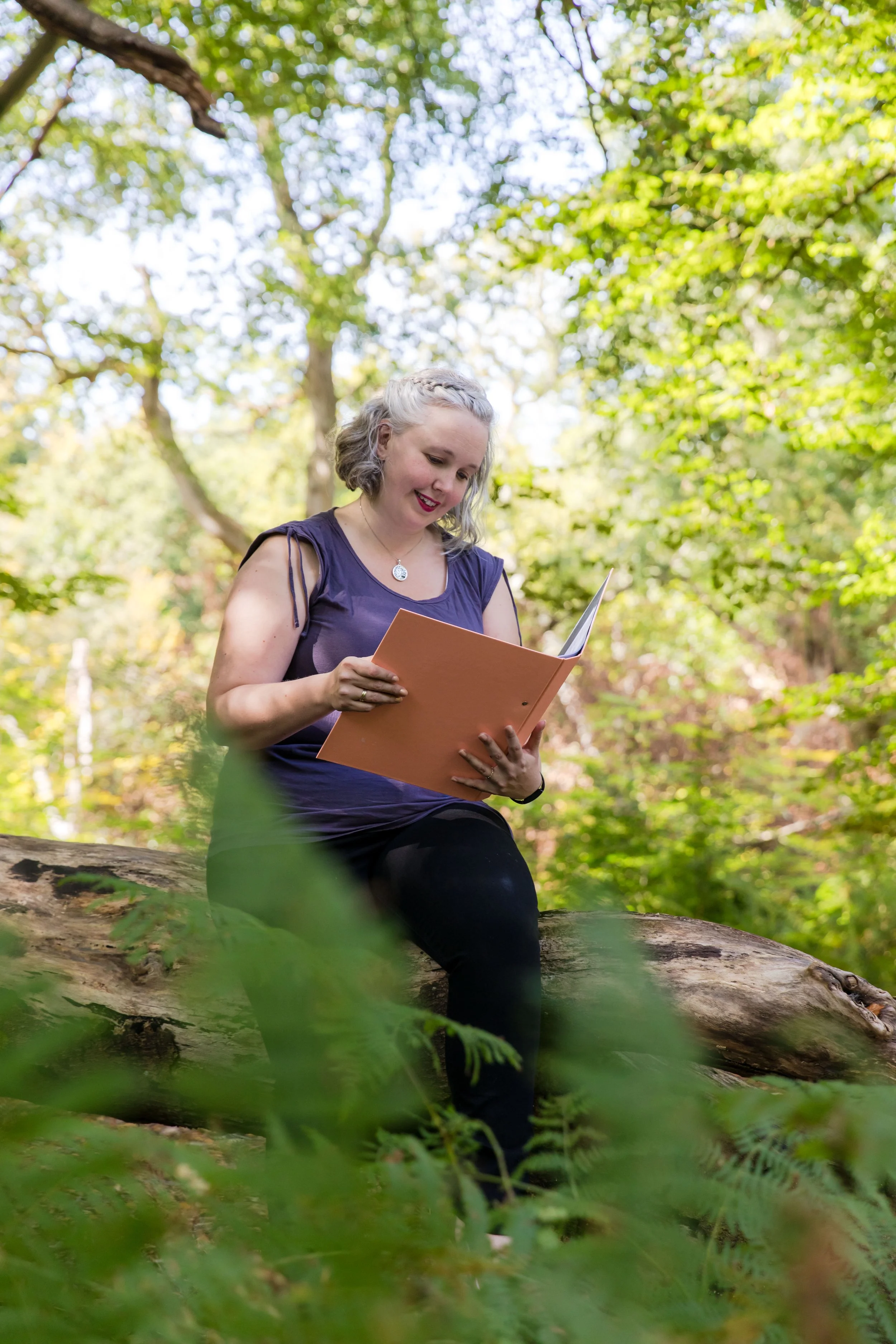 Celebrant Claire Dunford of Sakura Ceremonies sits in Wiltshire woodland planning a ceremony