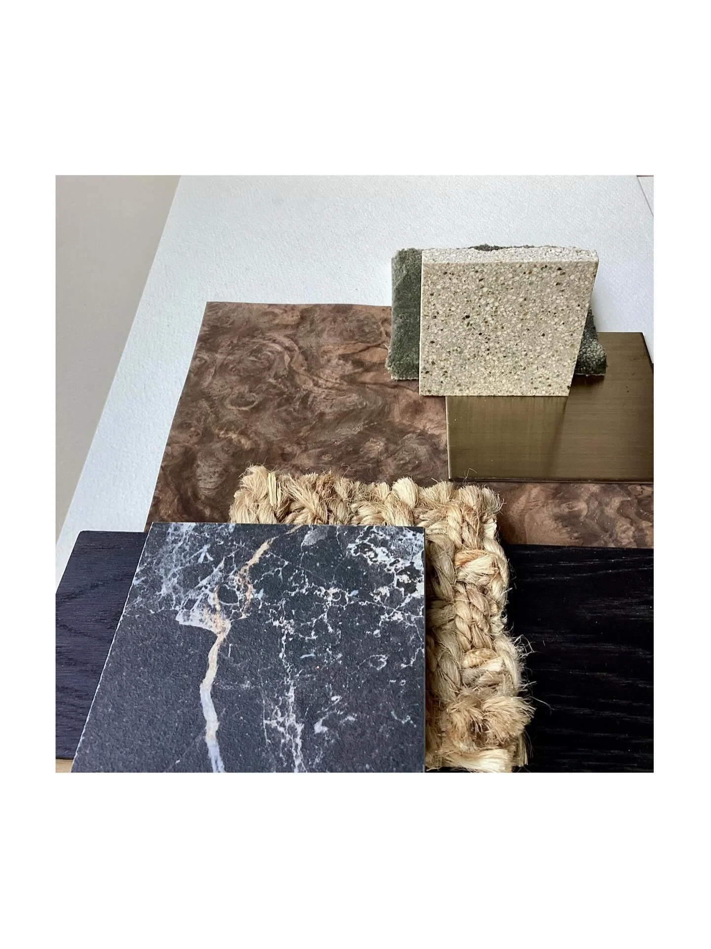 New Moodboard 

Layered Luxury, Grounded Elegance. A tactile story unfolds... walnut burr wood meets deep, dark flooring, anchored by soft jute rugs and luxurious carpet layers. Matt black stone with pink undertones contrasts a light terrazzo counter