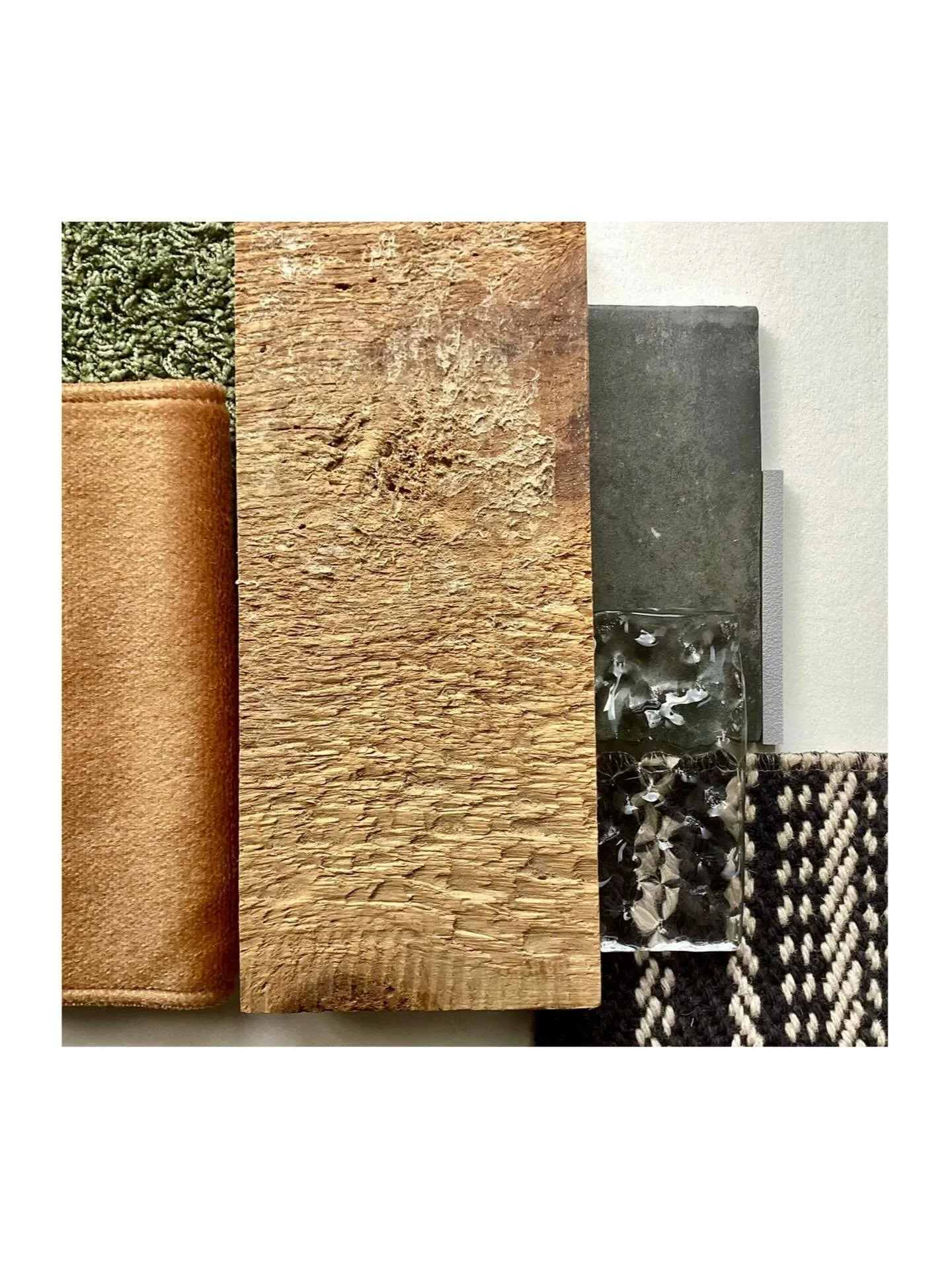 Warmth meets adaptability in this seasonal moodboard for a hospitality space. Rough wood wall finishes create a grounded, tactile backdrop, layered with a shaggy deep green rug and contrasted by warm brown velvet upholstery. A black and white herring