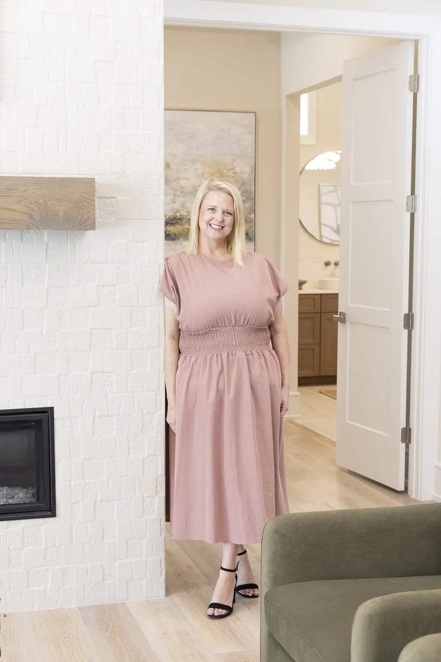 girl in pink dress standing in home