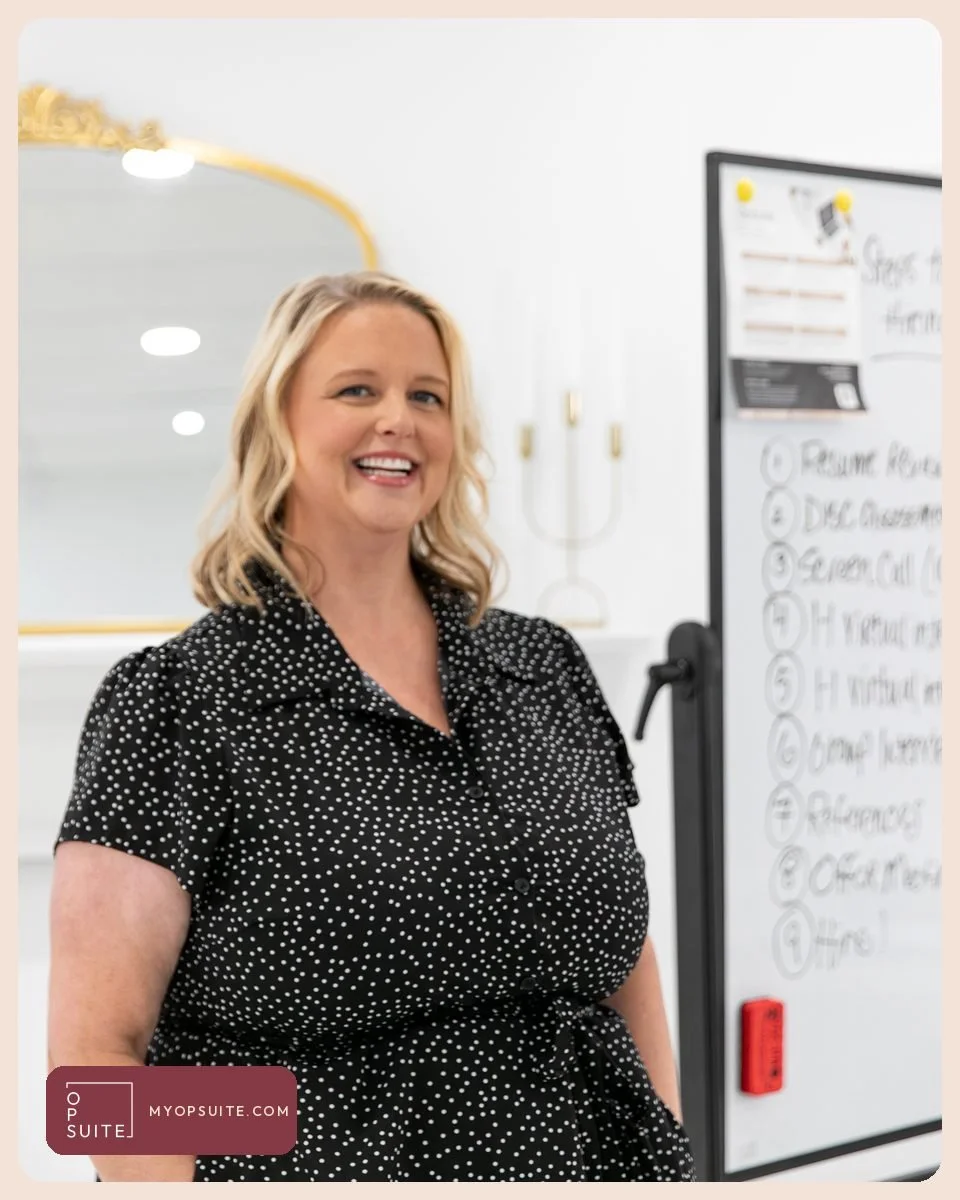 Samantha Cox smiling next to a whiteboard listing the steps of a real estate assistant hiring process