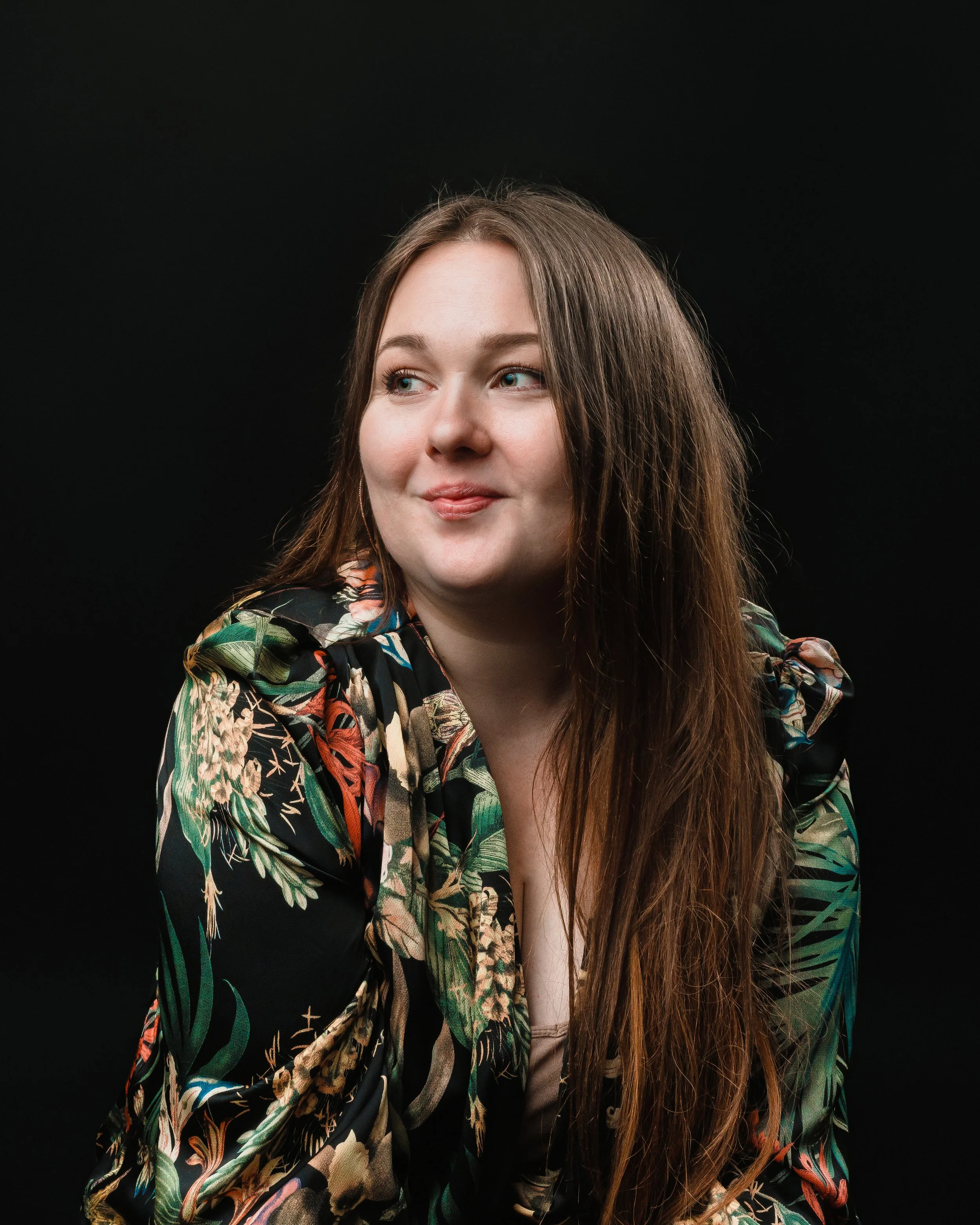 Kelsey Freeman in a studio portrait. She is looking off camera.