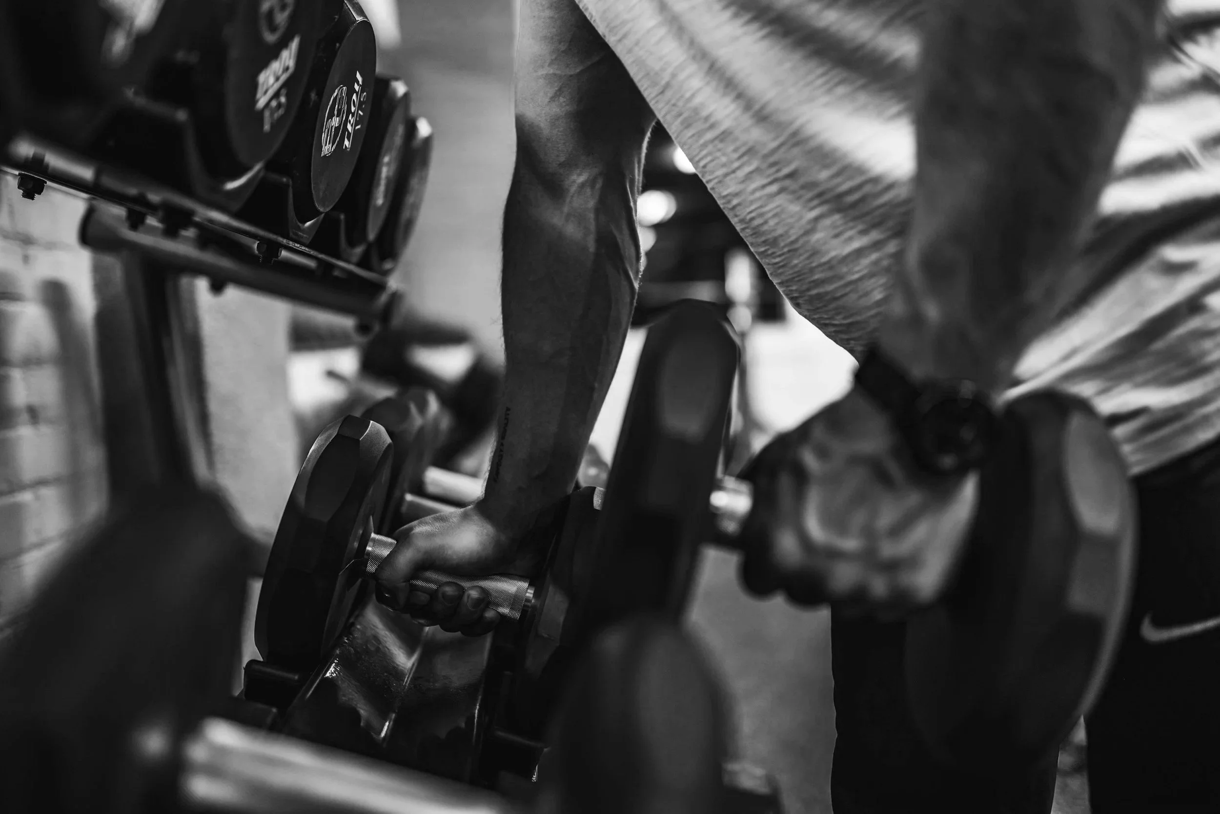 Strong arm picking up weights during a work out