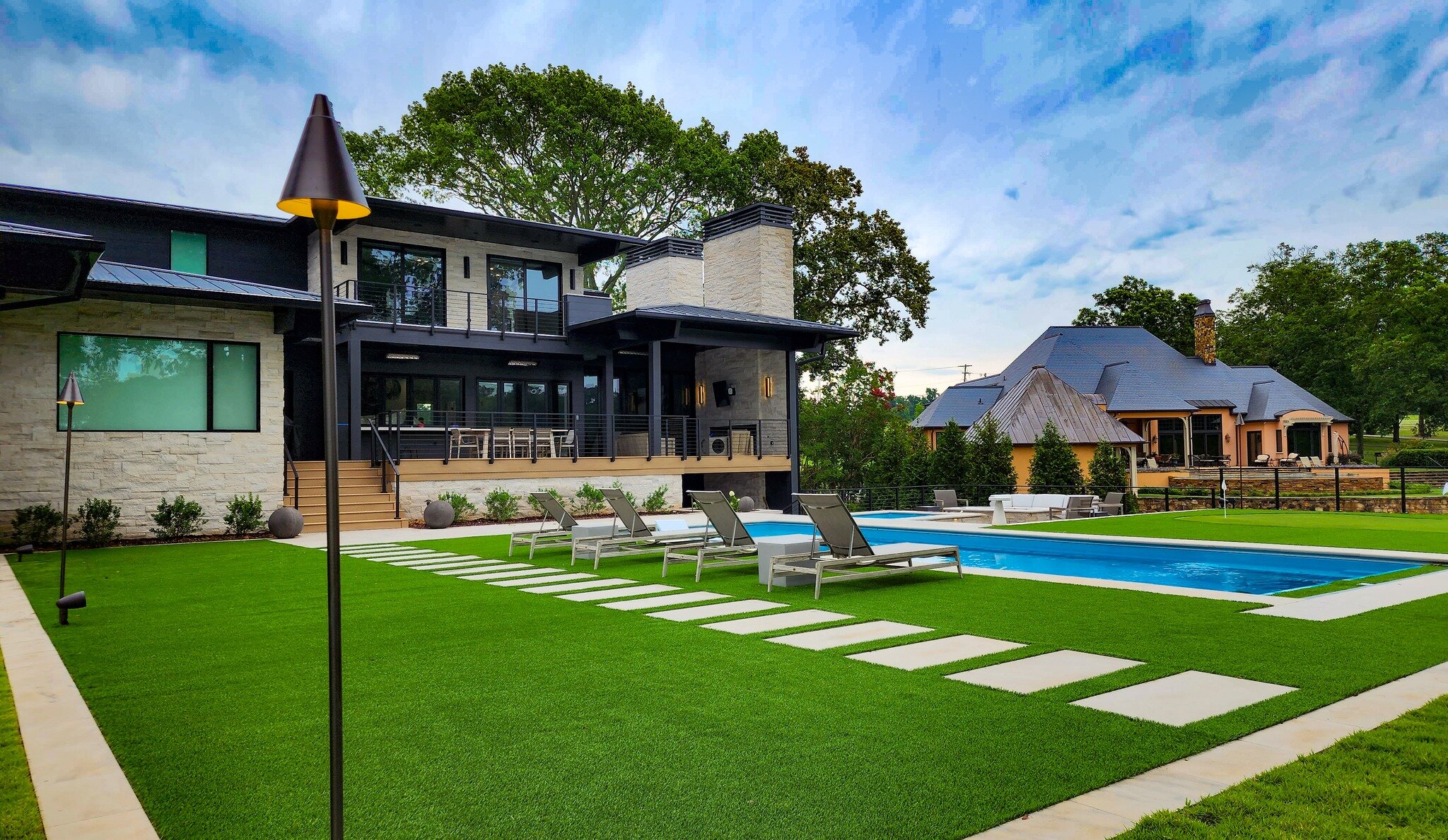 We are forever grateful to have had the opportunity to collaborate with @highcottonhomes on this stunning project. From the soft touch of fresh sod to the pristine artificial turf, this landscape features a custom putting green, large pavers for the 