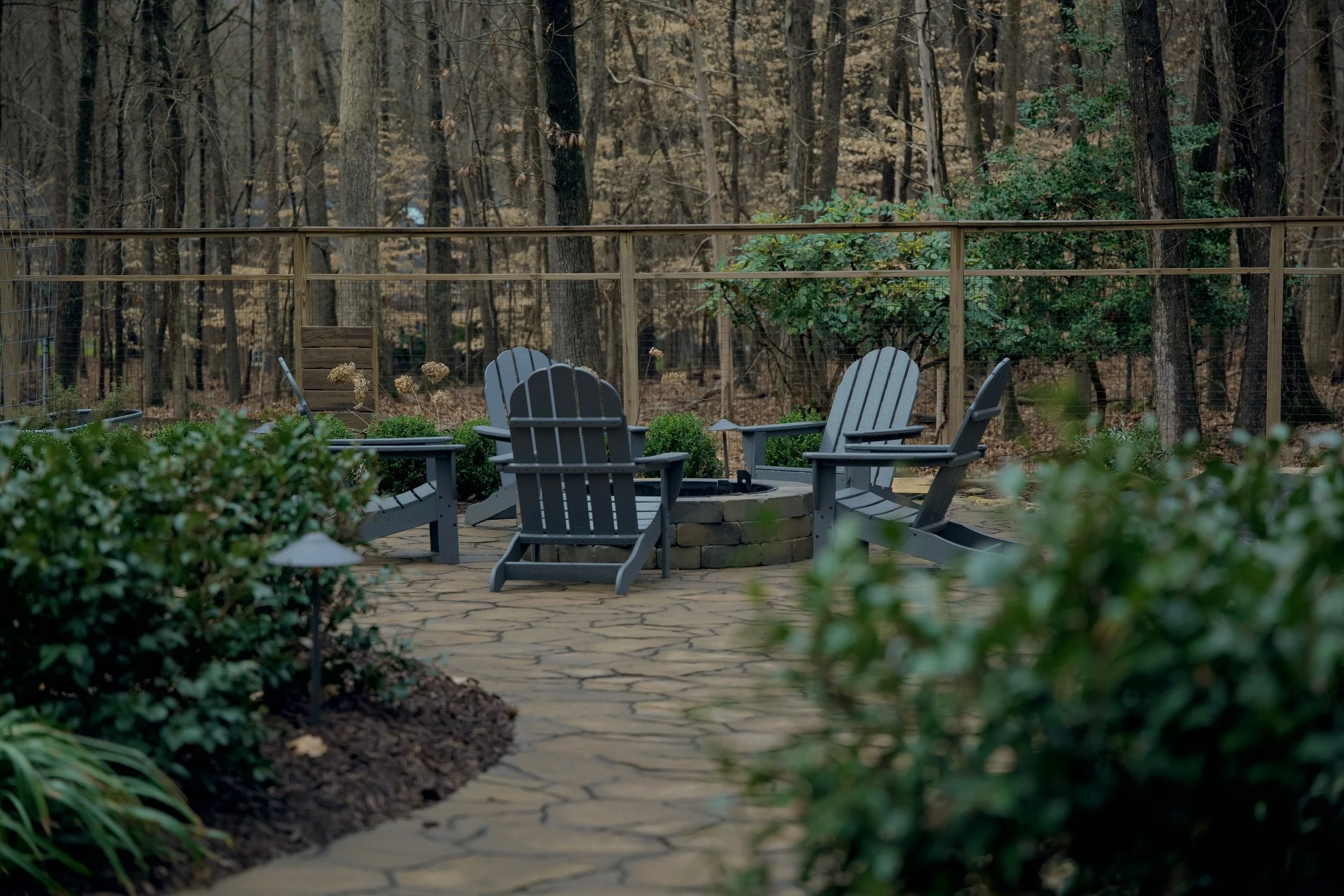 Large fireplace and patio with a cherry color pergola.