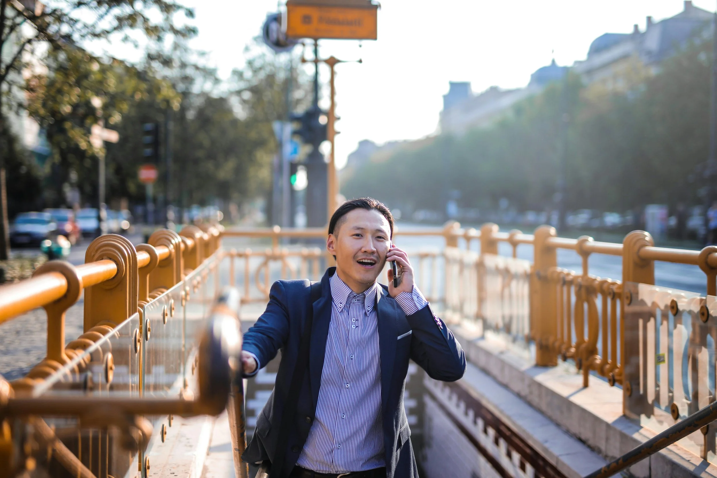 A man on the phone climbing up stairs towards the camera