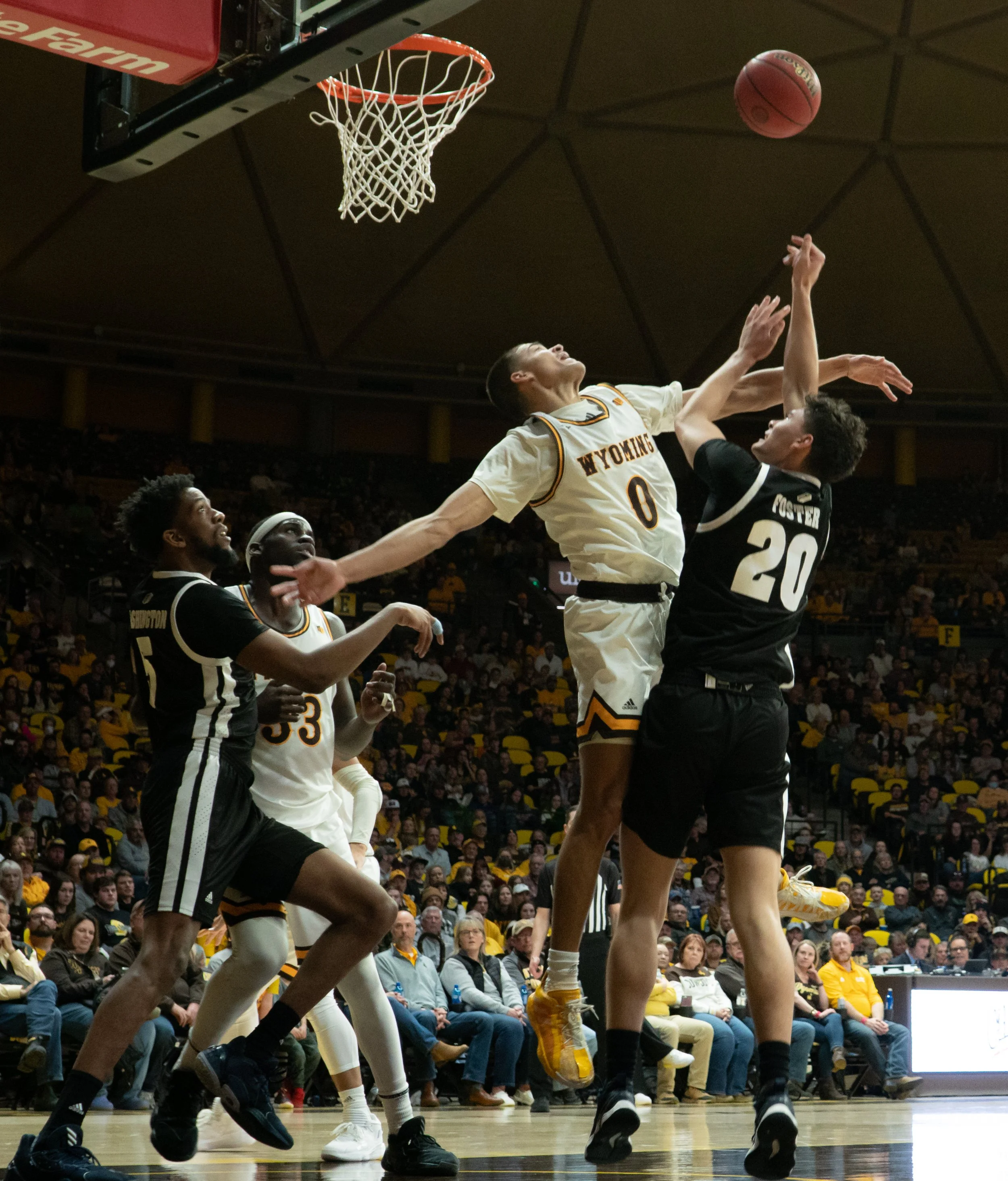 The Wyoming Cowboys’ Drake Jeffries (0) blocks Daniel Foster’s (20) shot for Nevada. Foster would shoot 0/5 on the night and Wyoming would win the game 74-61 on Feb. 26, 2022. Jeffries would finish the game with the block and three steals.