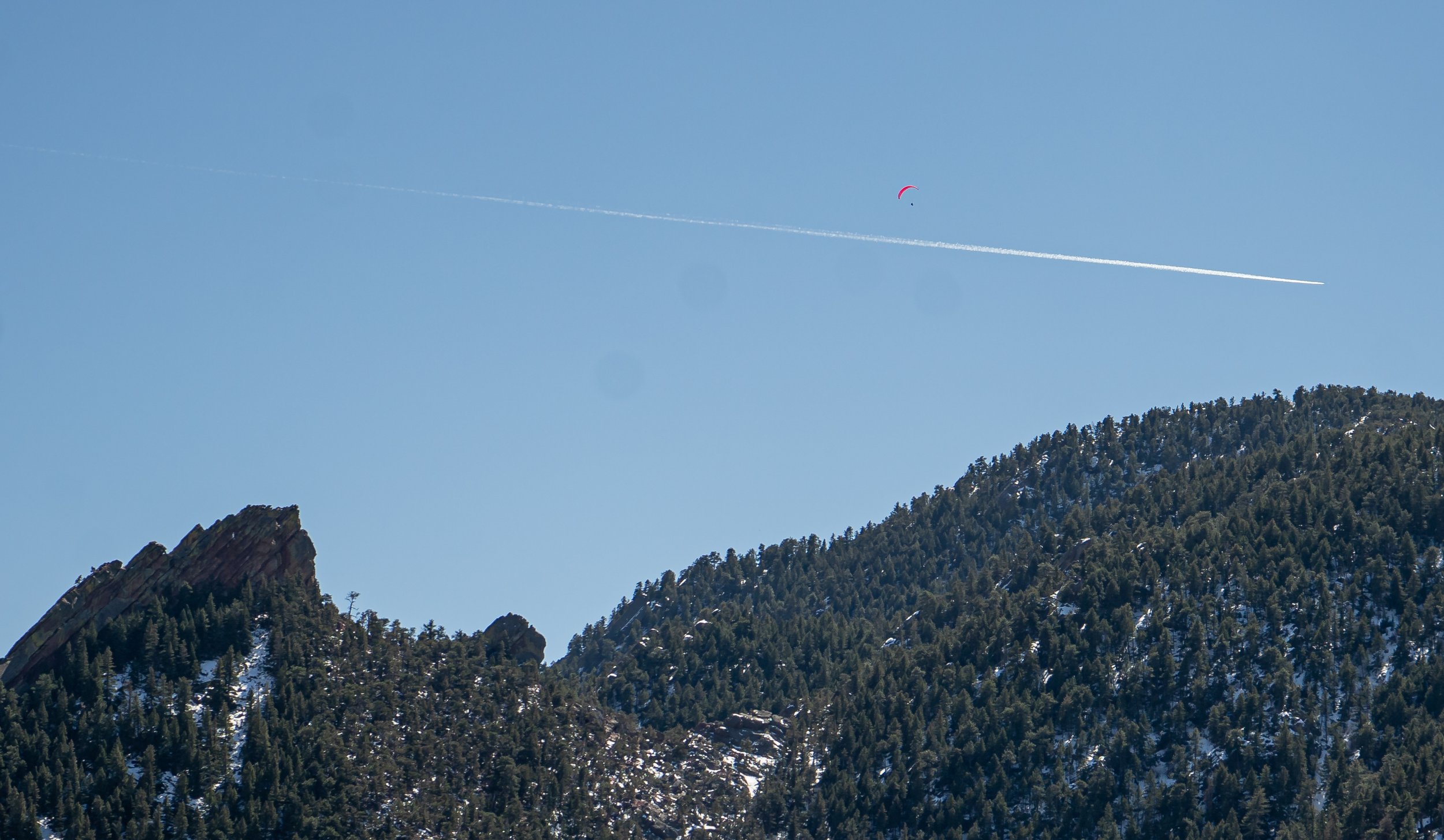 From Flagstaff Trail, the First Flatiron can be viewed just to the south and the city of Boulder, Colo. to the east. On a sixty degree March 14, 2022, the trails and outdoors were packed full of people. This included a paragliding, sunbathing and hik