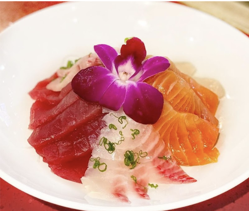 Colorful plate of sushi with purple orchid flower