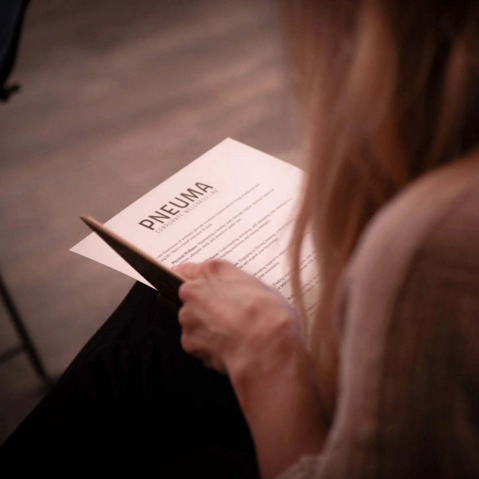Woman writing at a wellness workshop