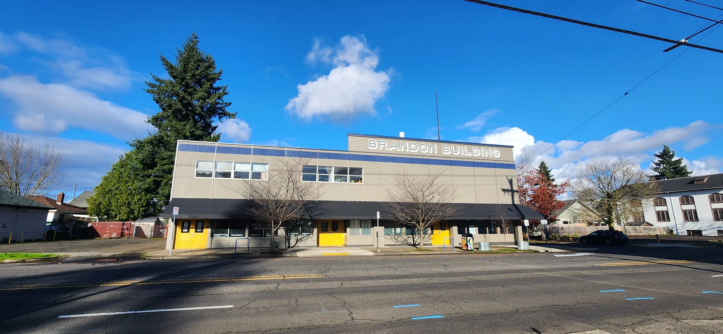 Photo of a typical two-story office building with blue skies, Keywords trauma therapist Oregon