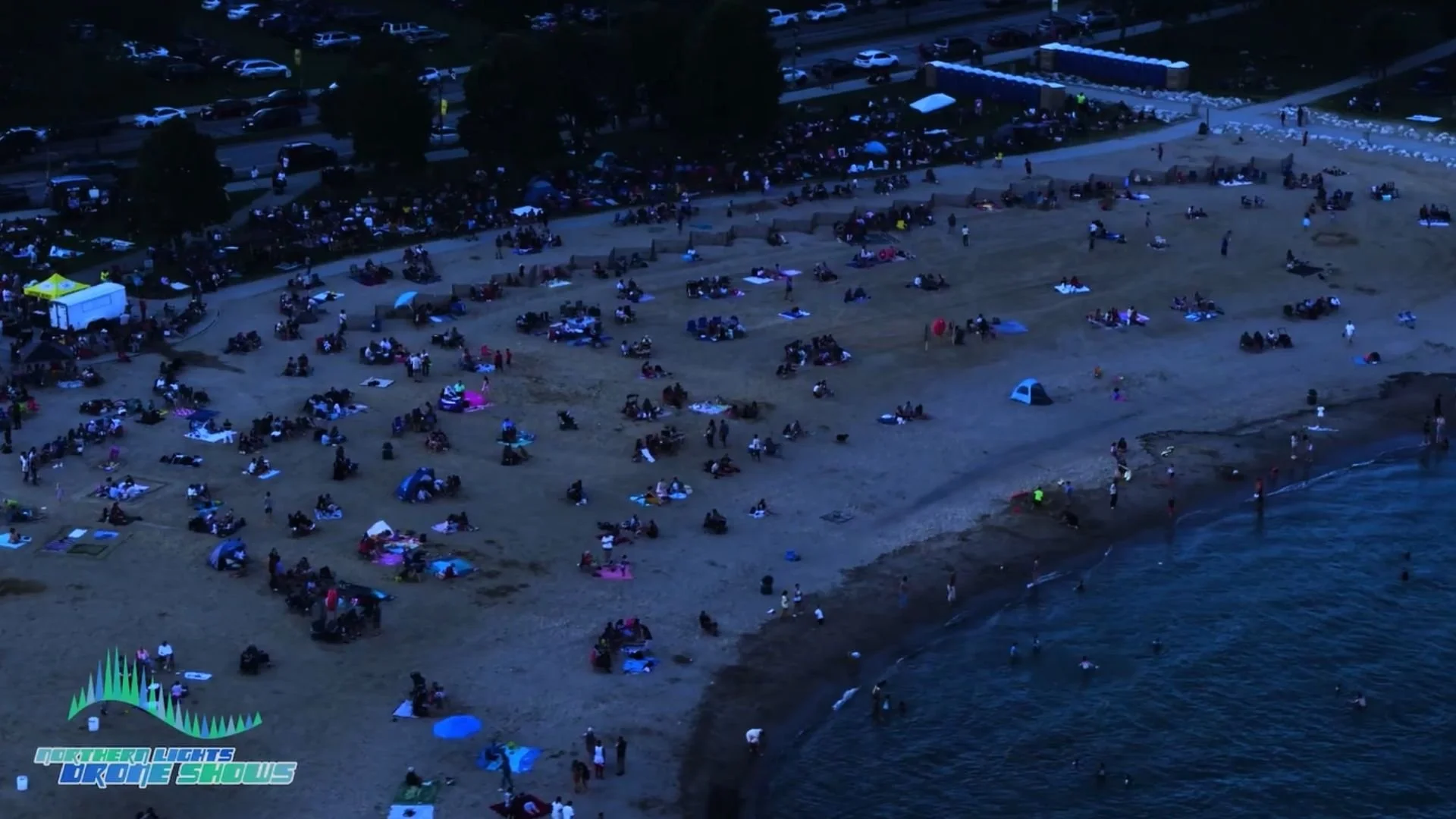An image from an NLDS drone show depicting the huge crowd gathered on the beach to watch the show.