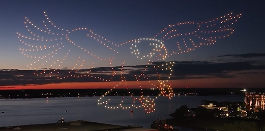 A drone show for a patriotic community event depicting a flying eagle with moving wings.