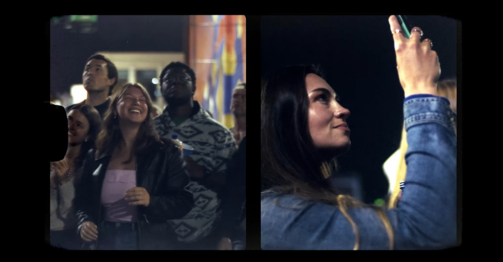 An image from an NLDS drone show depicting multiple spectators having a good time and recording.