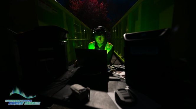 An image from an NLDS drone show showing one of our pilots overseeing a drone show from his control point.