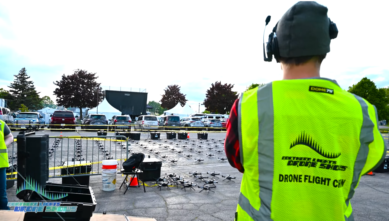 A picture depicting an NLDS Drone Flight Crew member performing routine safety inspections prior to a drone show.