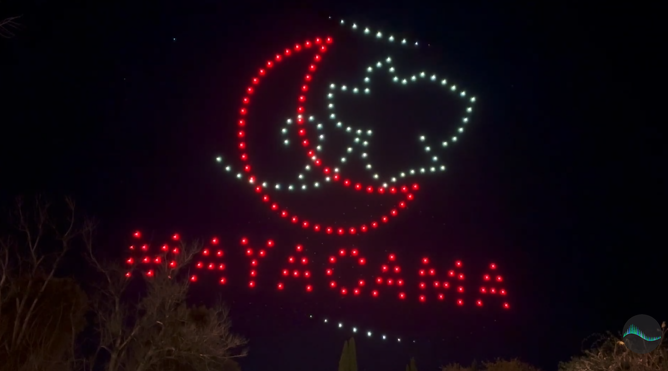 An image from a branded NLDS drone show showcasing a sponsor's logo.
