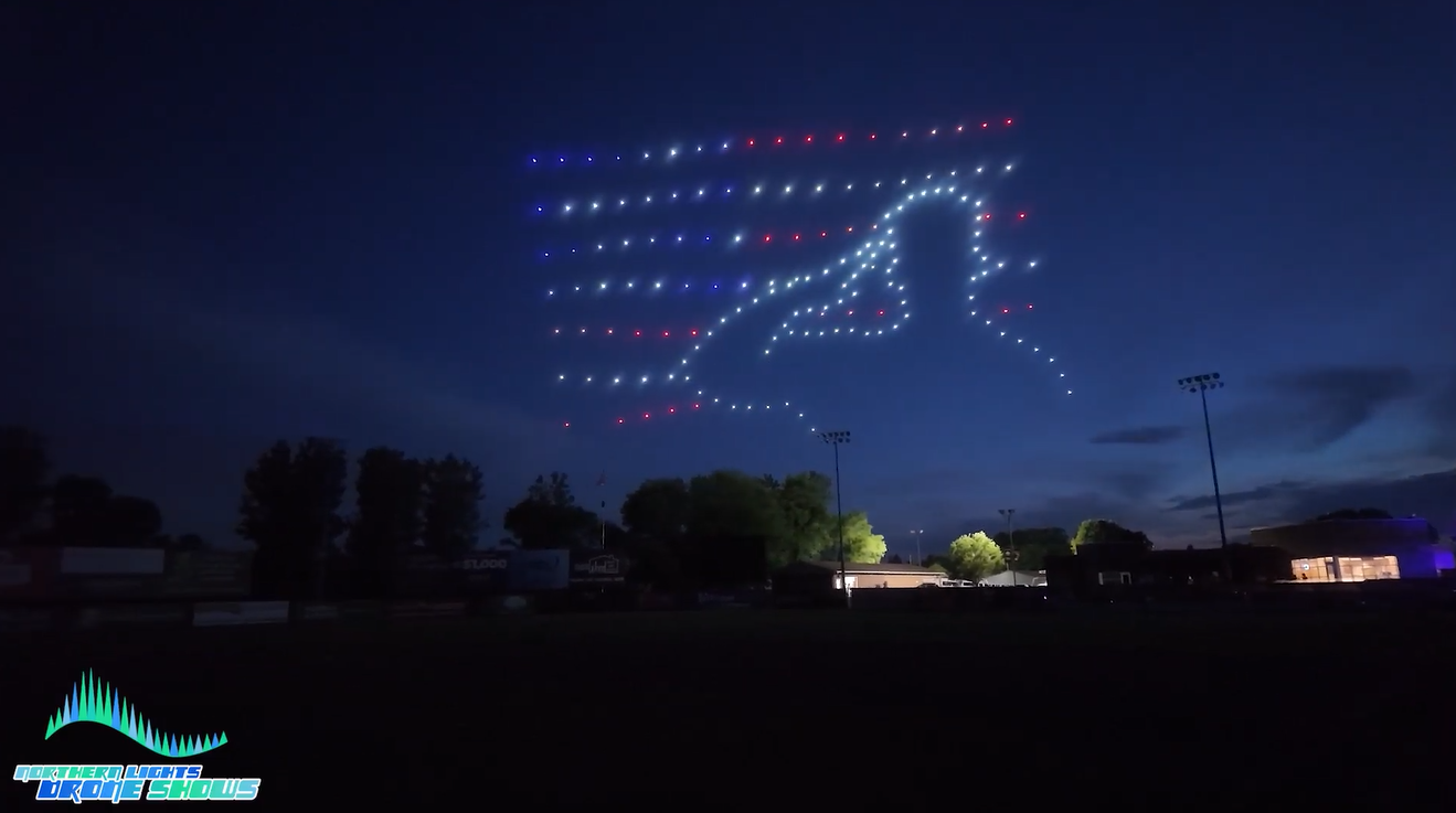 An NLDS drone show at a baseball game that is honoring service members in the audience.