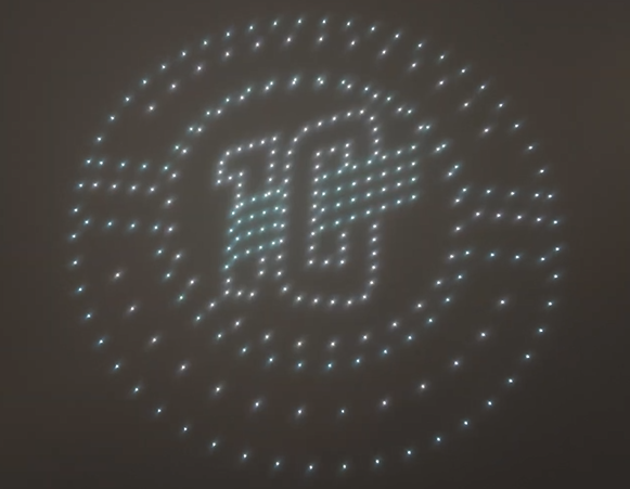A drone show organized into depicting both a sports team's logo and a 10-year anniversary symbol.