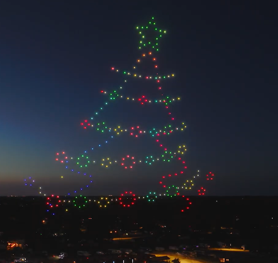 A drone show depicting a Christmas tree for a festive, holiday, community event.