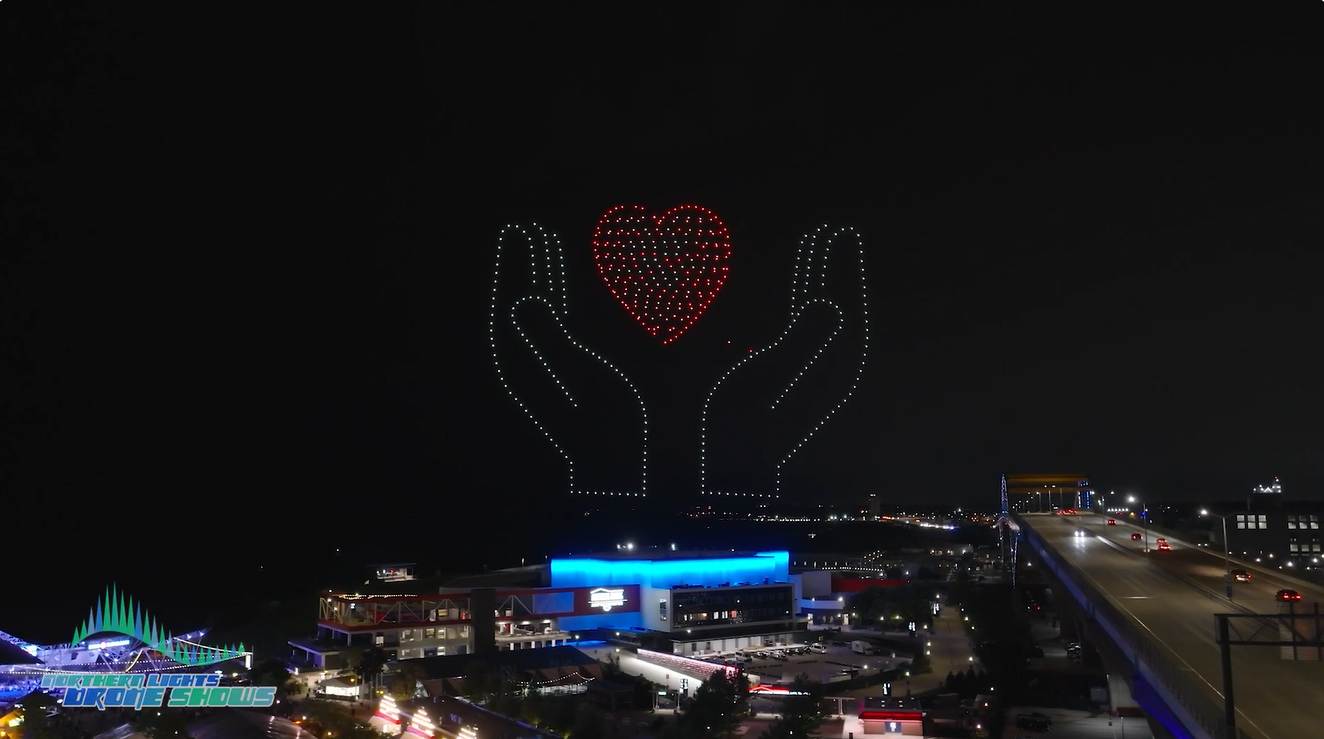 An image of two hands holding a heart at the Baird show.