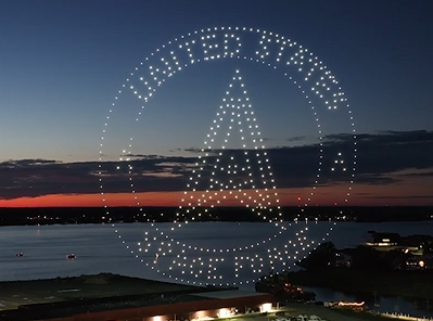 A drone show for a patriotic community event depicting the US Space Force's logo.