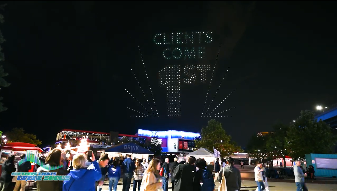 An image of an NLDS drone show presenting over a festival ground.