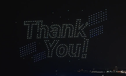 Drones in a drone show outlining the words "Thank you!" and moving around to make a cool set-piece.