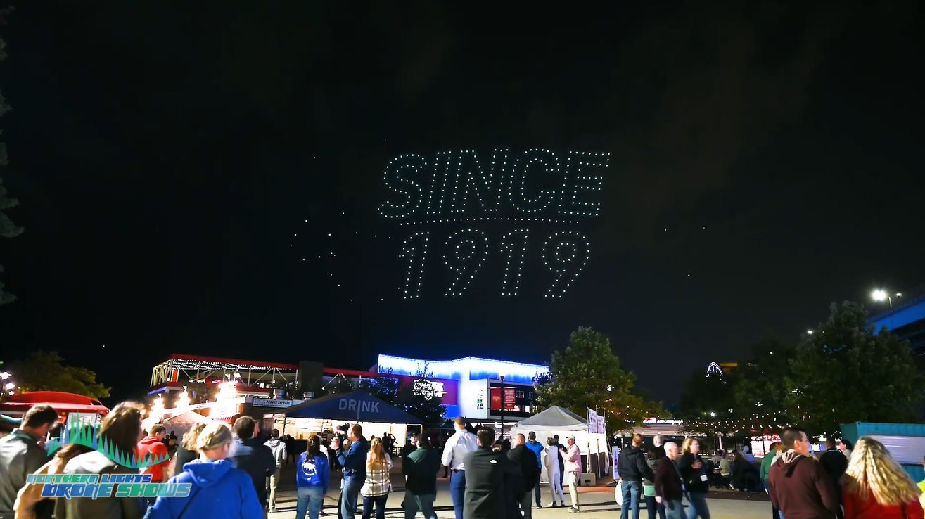 An image depicting a festival celebrating its 105th anniversary with a drone show by Northern Lights Drone Shows.