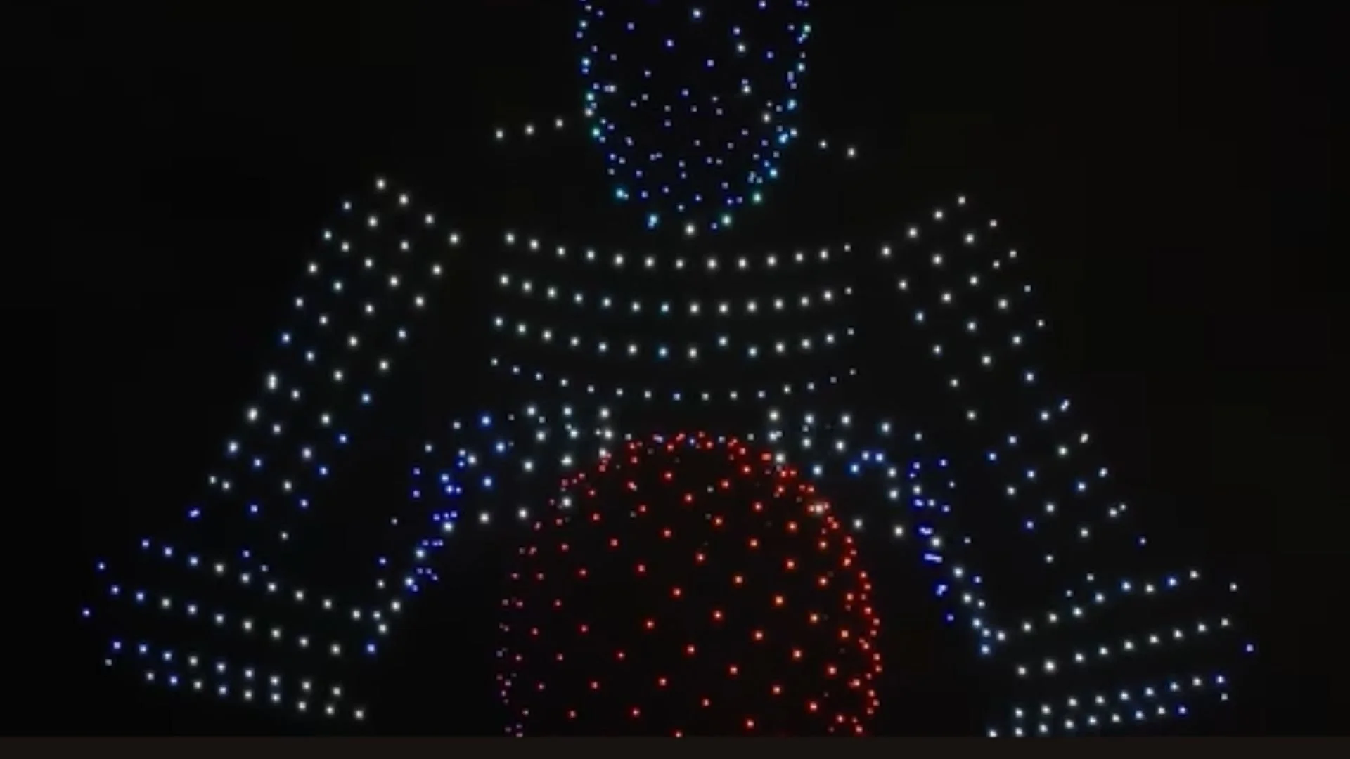 An image from an NLDS drone show depicting the drones taking the form of Tesla's Optimus.